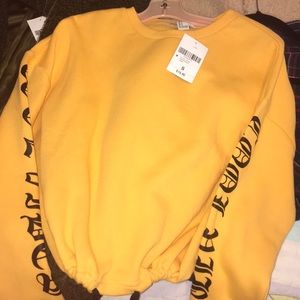 Yellow sweater ties up to be more cropped